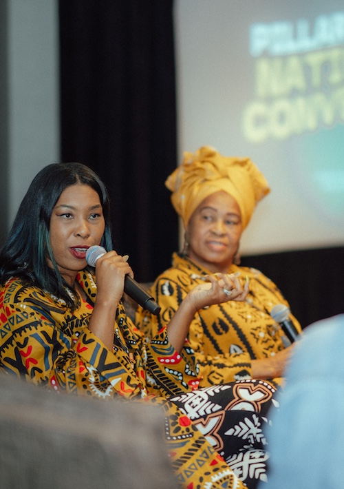 A photo of mother-daughter duo Asselah Rashid and Sister Okolo Rashid speaking onstage during a convening panel session