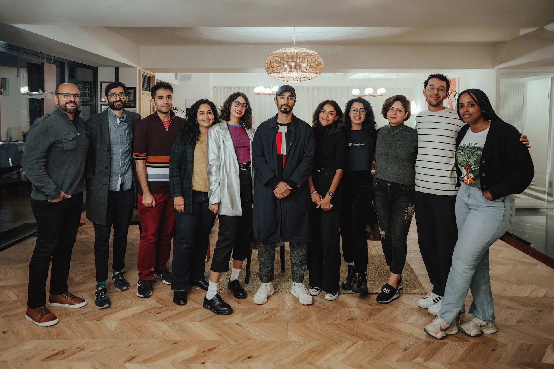 A group photo of the ten 2022-23 Pillars Artist Fellows with actor and advisor Riz Ahmed